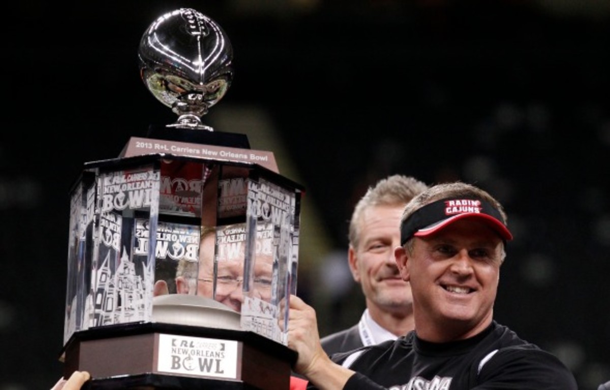 Louisiana-Lafayette head coach Mark Hudspeth celebrates a third straight New Orleans Bowl win. (AP Photo/Bill Haber)