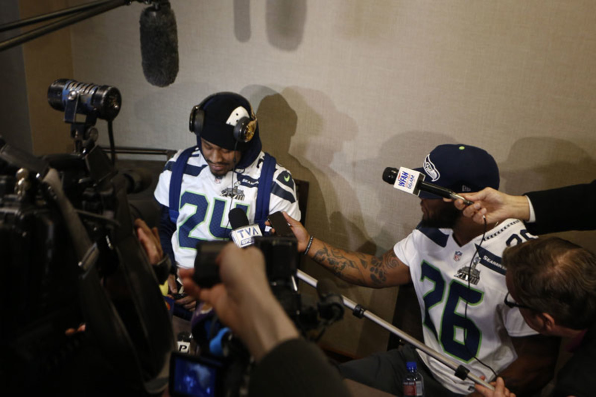 Marshawn Lynch needed help from teammate Michael Robinson to say nothing to the media on Wednesday. ( Jeff Zelevansky/Getty Images)