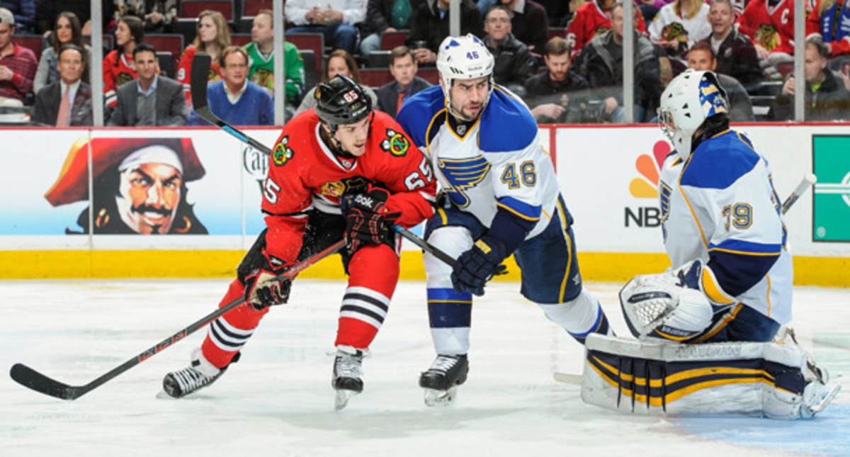 Andrew Shaw of the Chicago Blackhawks and Ryan Miller of the St. Louis Blues