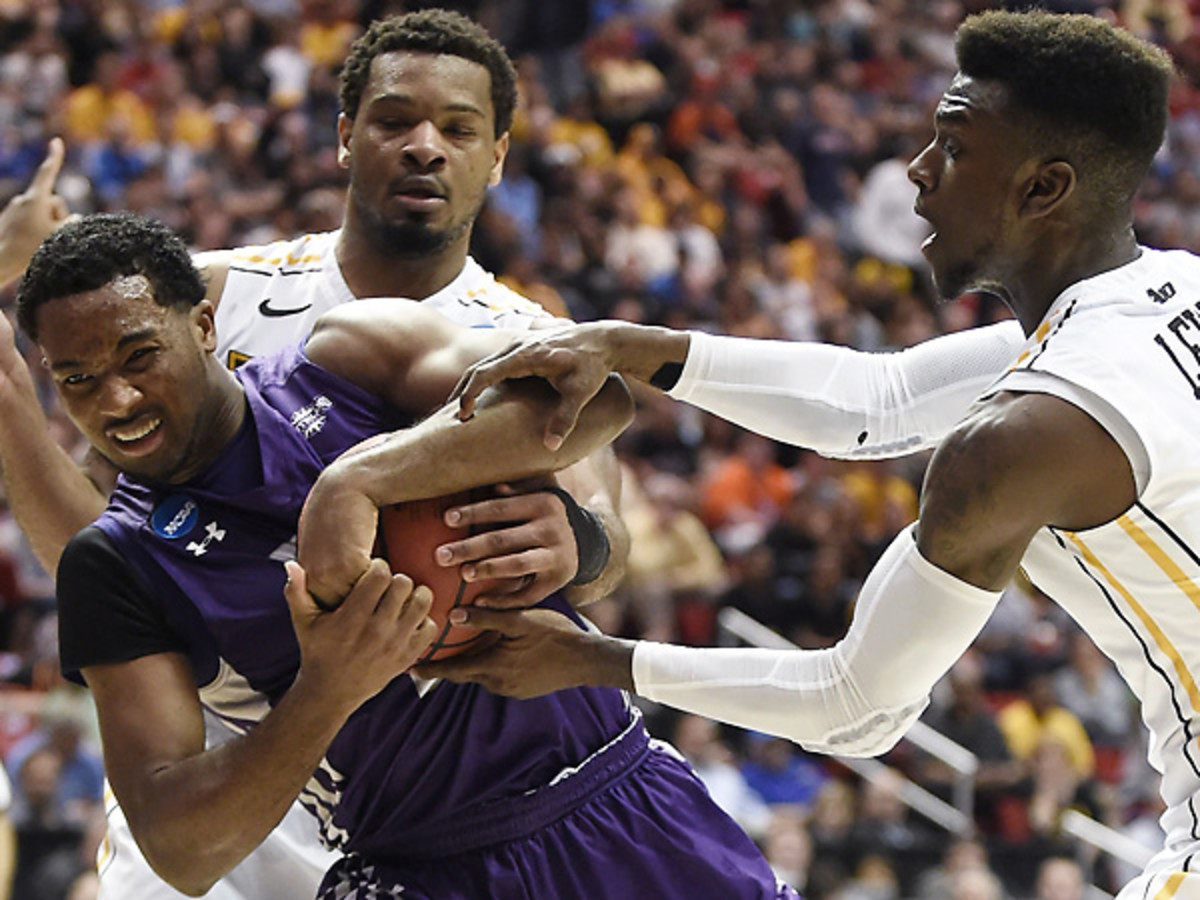 Desmond Haymon (left) had some issues with VCU's press, but would come up with the game-tying four-point play. (Denis Poroy/AP)