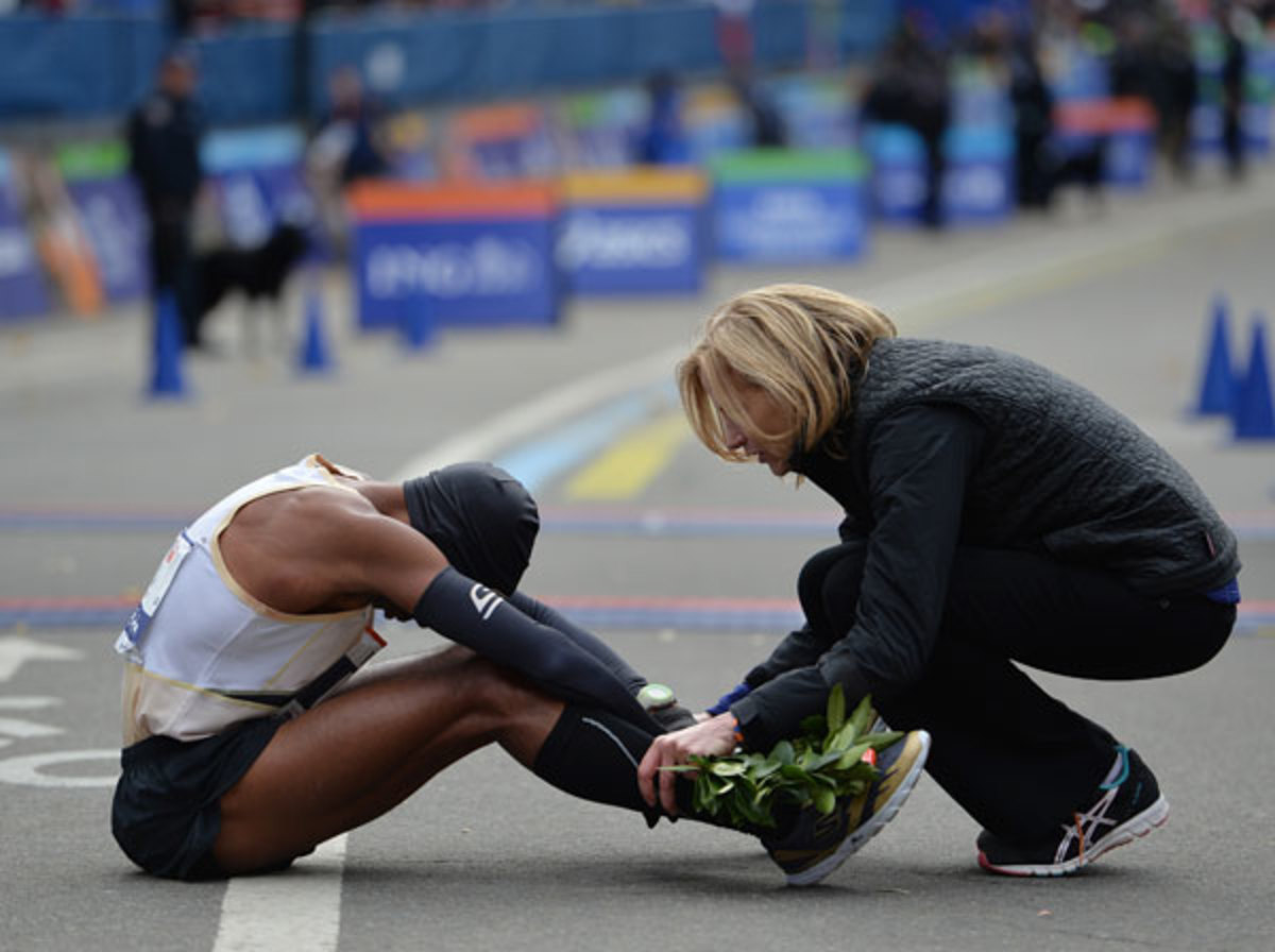 Meb Keflezighi is greeted by New York Road Runners President Mary Wittenberg after he crossing the finish line in the New York City Marathon in November 2013.