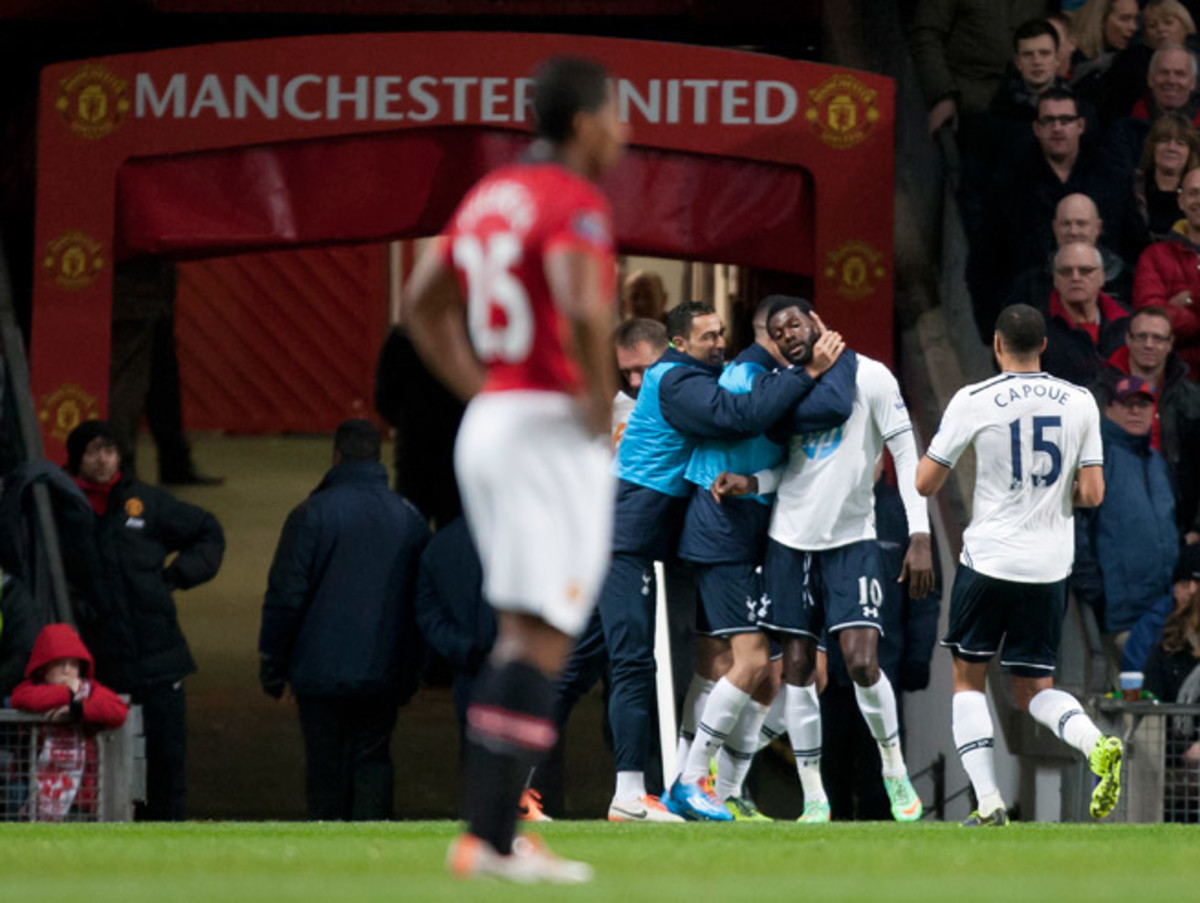 Manchester United's Antonio Valencia can do nothing but try to look away as Tottenham celebrates Emmanuel Adebayor's opener at Old Trafford Wednesday.