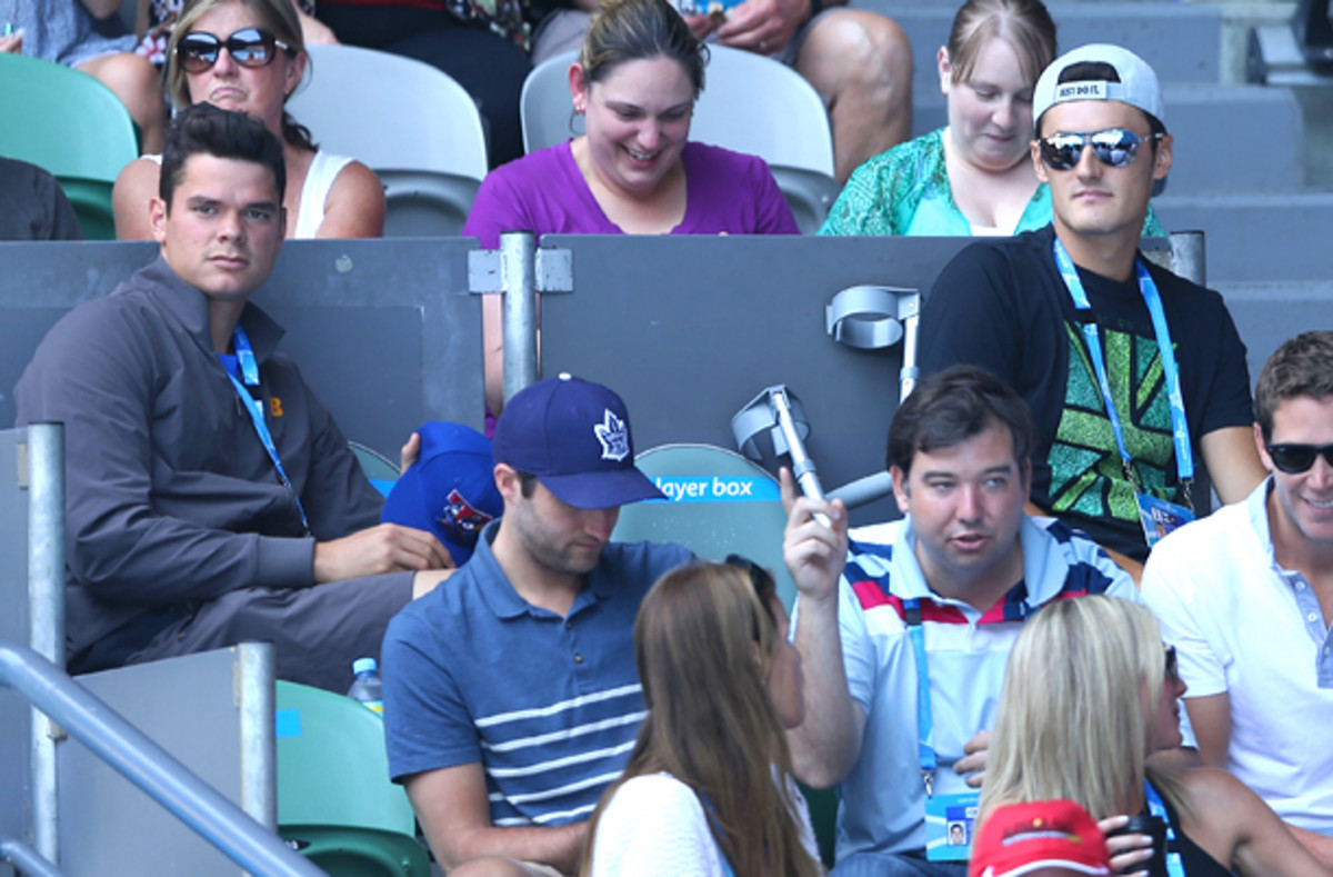 Milos Raonic and Bernard Tomic sit in Li Na's player box. (Clive Brunskill/Getty Images)