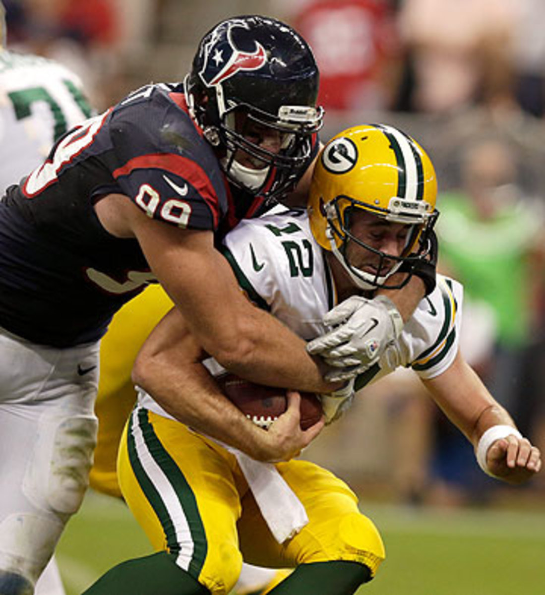 The MVP race is expected to come down to J.J. Watt and Aaron Rodgers, shown here in 2012. (Scott Halleran/Getty Images)