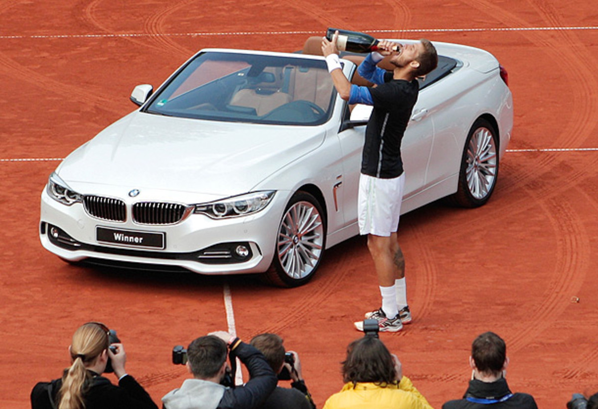 Martin Klizan celebrates his victory at the BMW Open with the winner's car. (Mark Wieland/Getty Images)