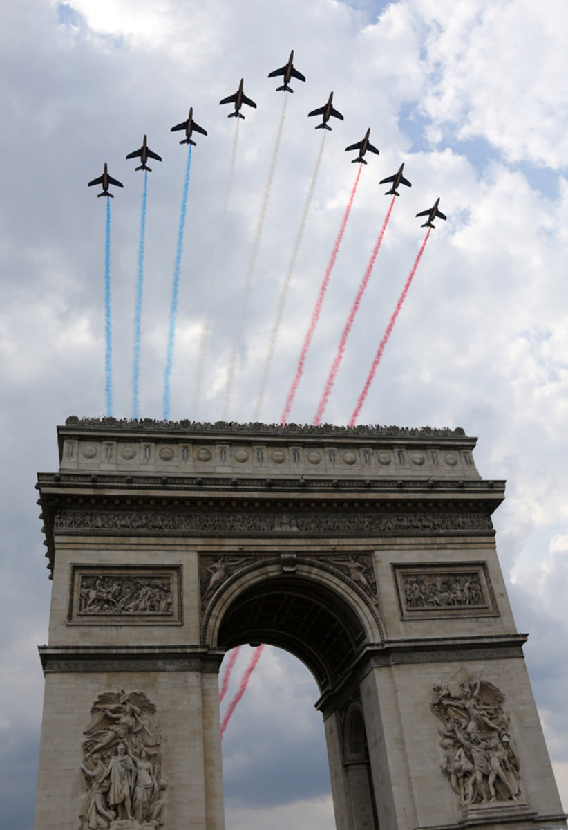 The French Air Force aerobatics squad, the Patrouille de France, flies over the Arc de Triomphe to celebrate the twenty one and last stage of the 2014 Tour de France.