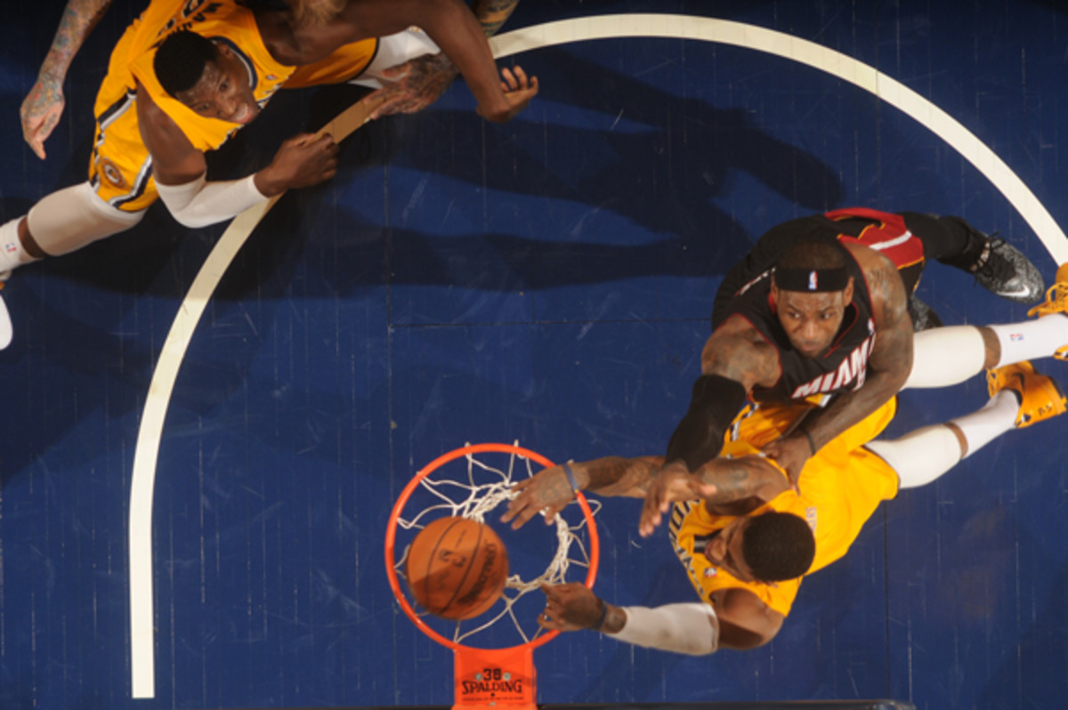 Pacers forward Paul George dunks over Heat forward LeBron James. (Ron Hoskins/Getty Images)