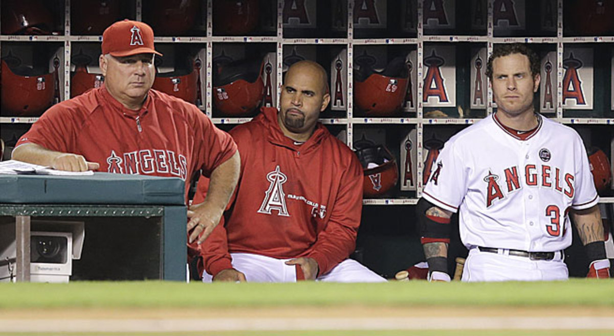Mike Scioscia (left) could be in trouble as Angels manager if Albert Pujols (middle) and Josh Hamilton don't return to form.