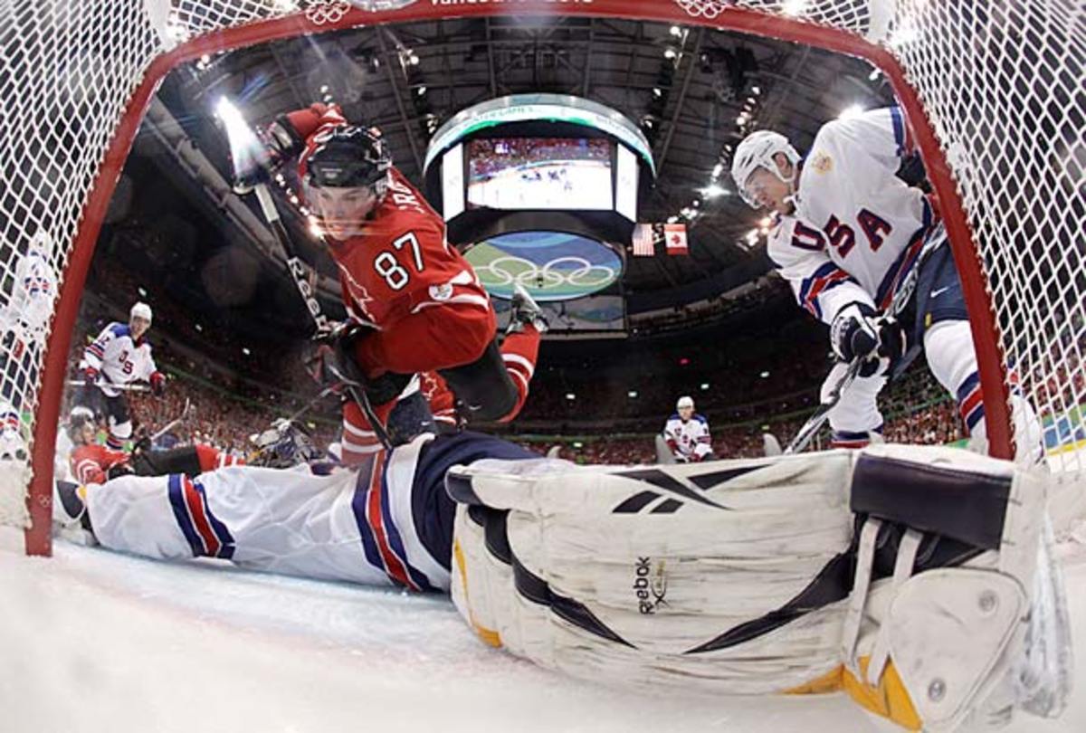Sidney Crosby drives the net against Ryan Miller and Team USA at the 2010 Winter Olympics in Vancouver.