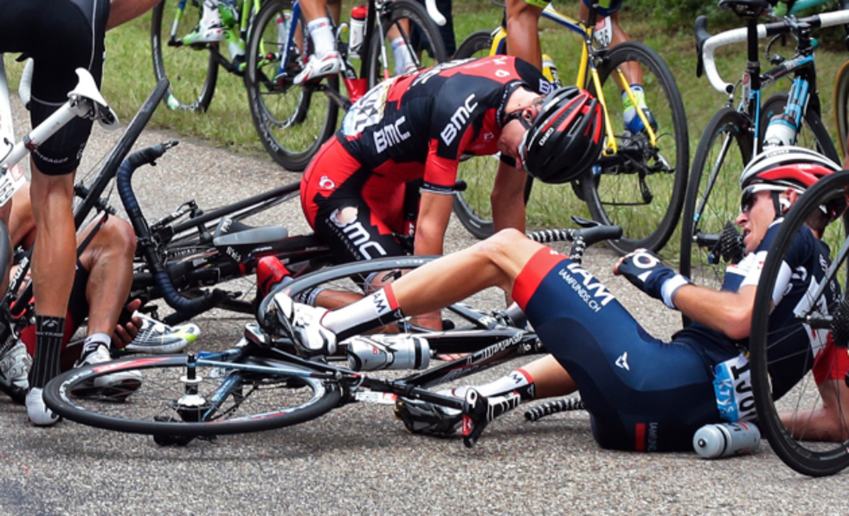 Tejay van Garderen of the U.S., center top, and Switzerland's Sebastien Reichenbach, right, crash during the seventh stage of the Tour de France cycling race over 234.5 kilometers (145.7 miles) with start in Epernay and finish in Nancy, France, Friday, July 11, 2014.
