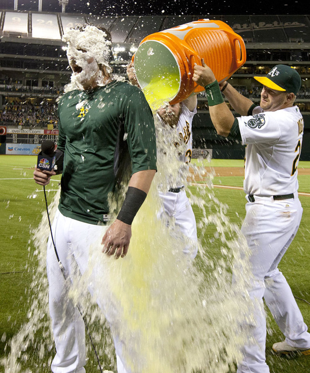 0718-Josh-Donaldson-doused-by-Derek-Norris-Stephen-Vogt.jpg