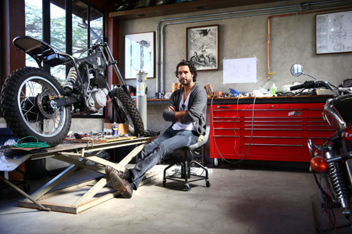 Fabio Diniz poses inside his custom motorcycle shop, which sits above his bar, Rock N Cycles, in the Vila Madalena area.