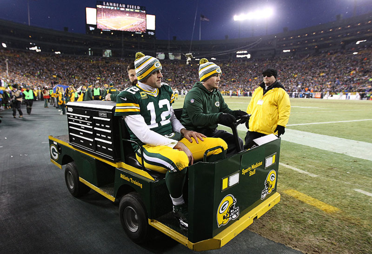 Aaron Rodgers was carted into the locker room with a calf injury Sunday, but he returned to help lead the Packers to the NFC North title. (Chris Graythen/Getty Images)