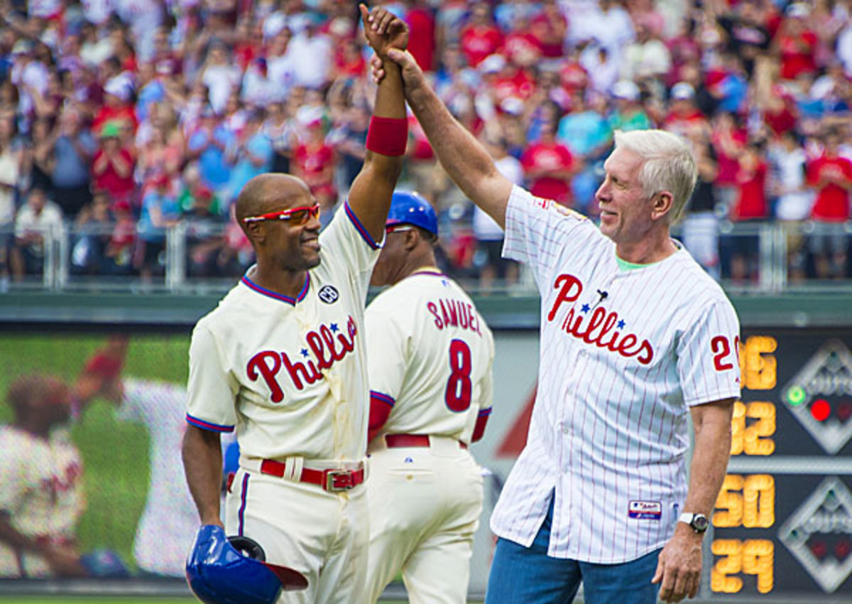 Jimmy Rollins (left) is greeted at first base by Mike Schmidt, the man whose hit record he broke. (Gavin Baker/Icon SMI)