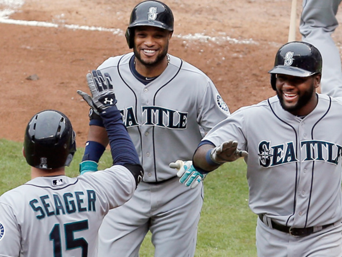 Robinson Cano is congratulated after hitting his first homer as a Mariner on Thursday. (Brandon Wade/AP)