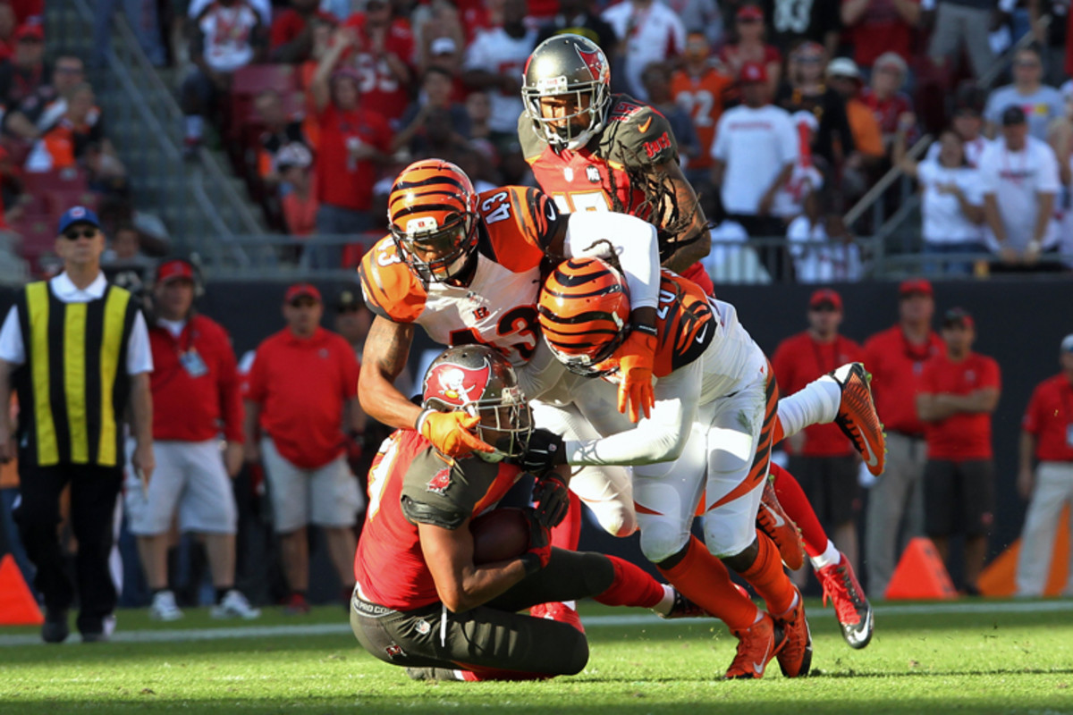 George Iloka (43) and Reggie Nelson (20) combine to make the tackle on the Bucs’ Charles Sims. (Cliff Welch/Icon SMI)