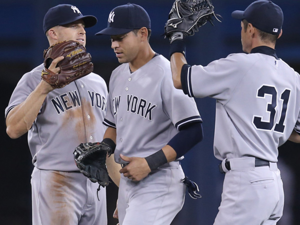 Buoyed by new arrivals like jacoby Ellsbury (center), New York sits in first place in the AL East. (Tom Szczerbowski/Getty Images)
