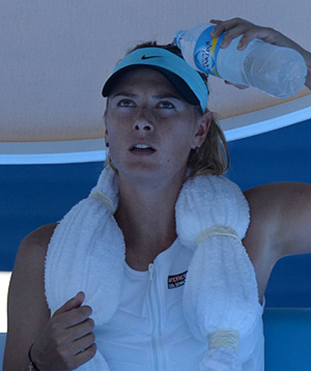 Maria Sharapova dumps water on her head while wearing an ice vest to try and stay cool at the Australian Open. (MAL FAIRCLOUGH/AFP/Getty Images)
