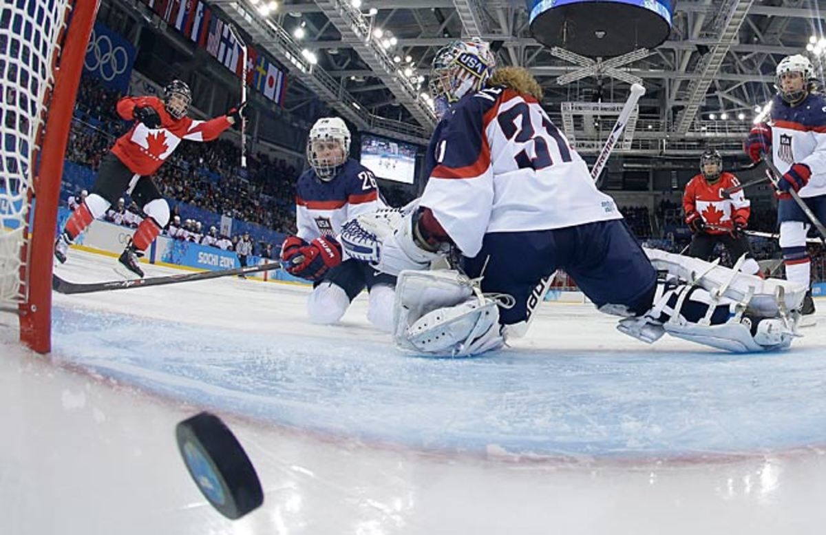 USA goalie Jessie Vetter looks back at the winning goal by Canada's Meghan Agosta-Marciano (left).