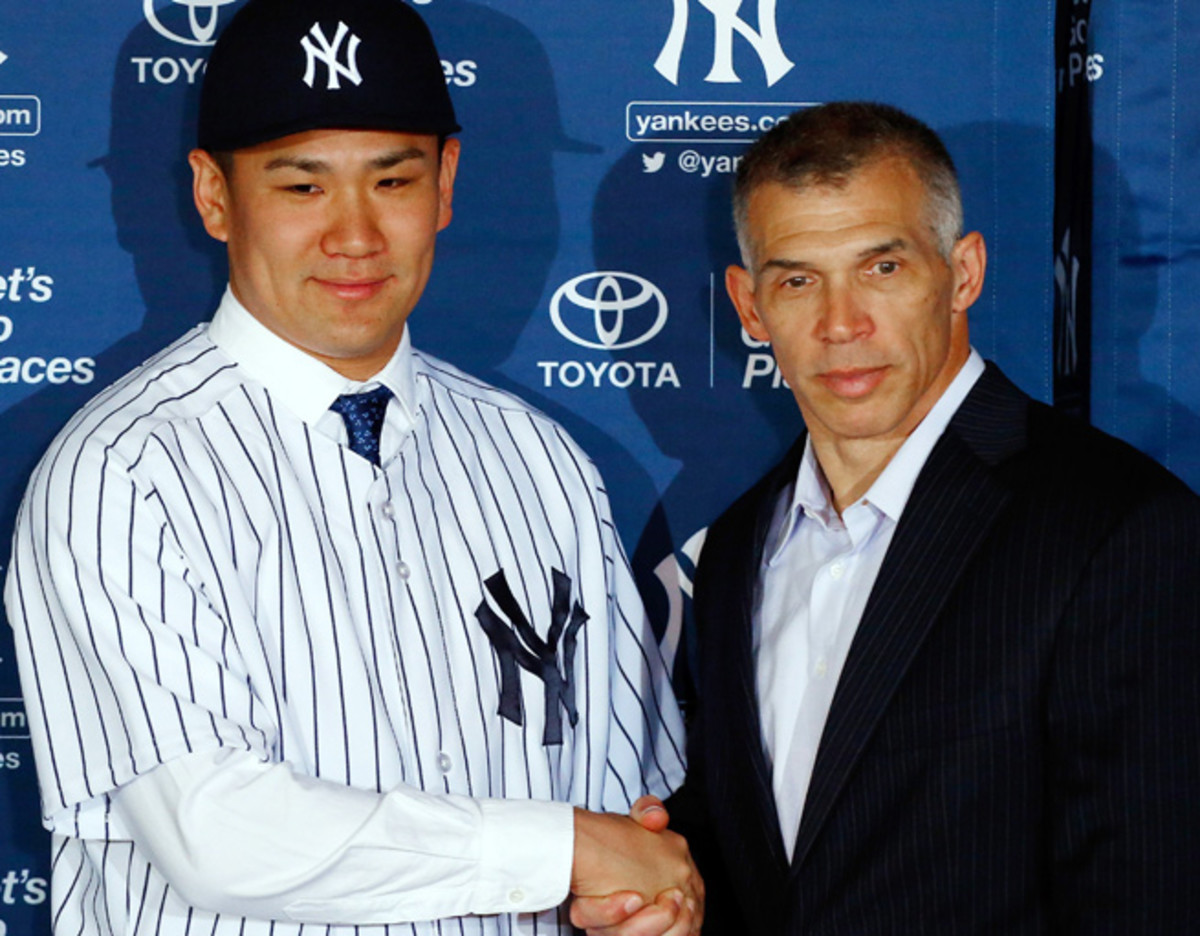 Masahiro Tanaka shakes hands with Joe Girardi during his introductory press conference in January.