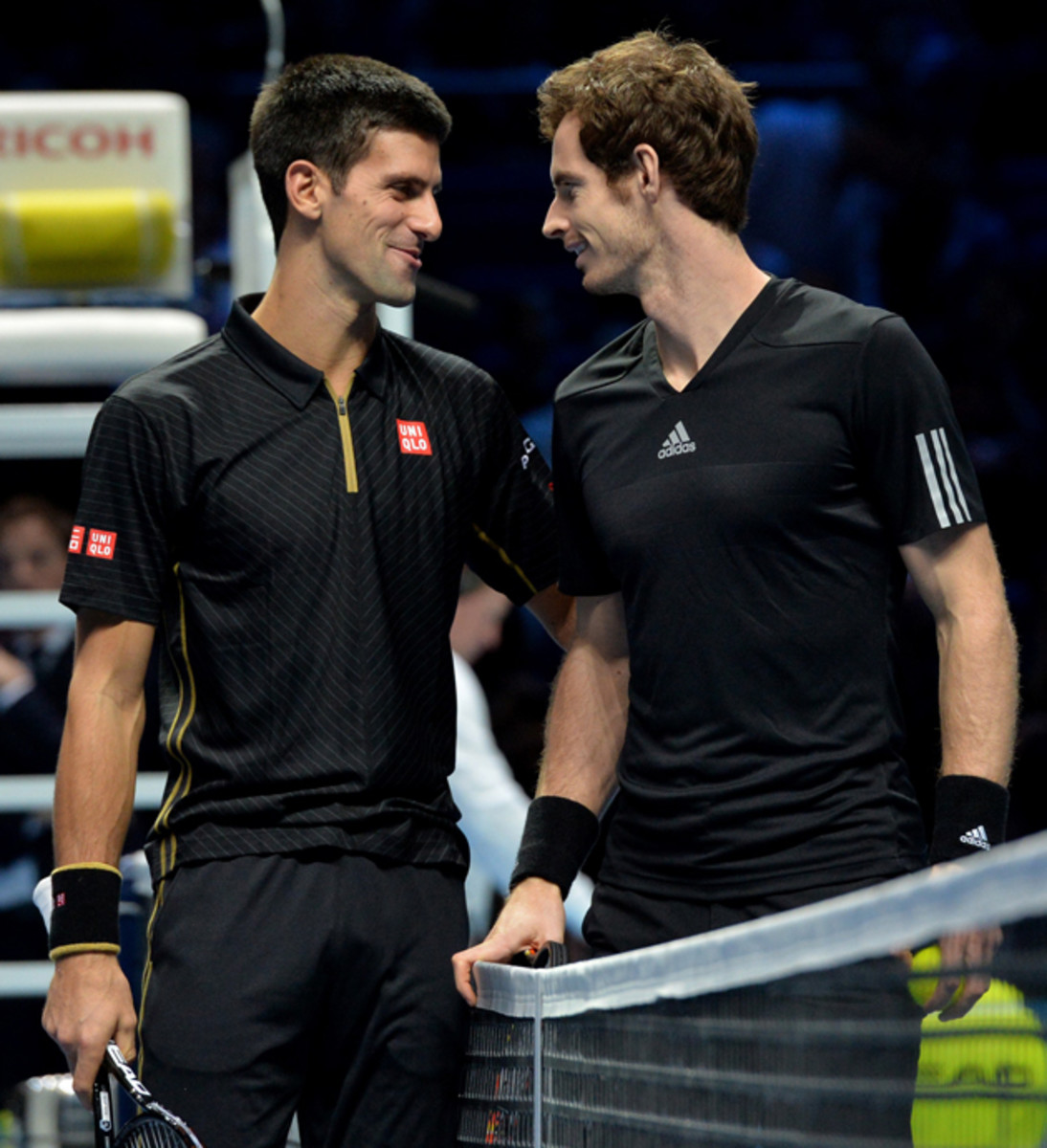Djokovic and Murray share a moment before their exhibition match after Federer withdrew from the ATP Finals title match.