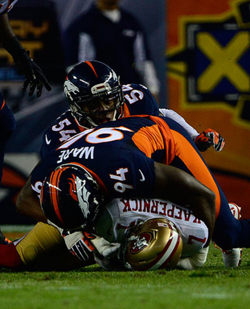 Colin Kaepernick was sacked six times by the Broncos defense on Sunday night. (Joe Amon/Getty Images)
