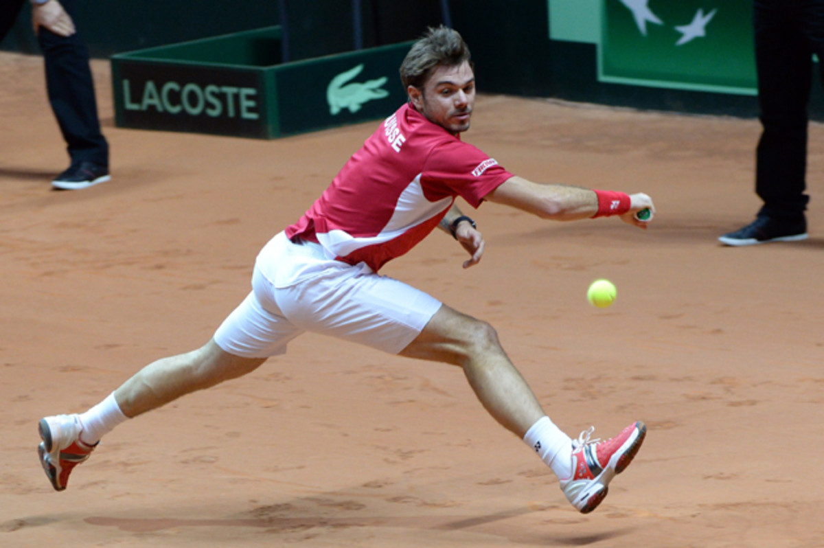 Wawrinka returns a backhand to Tsonga during the first match of the Davis Cup final.