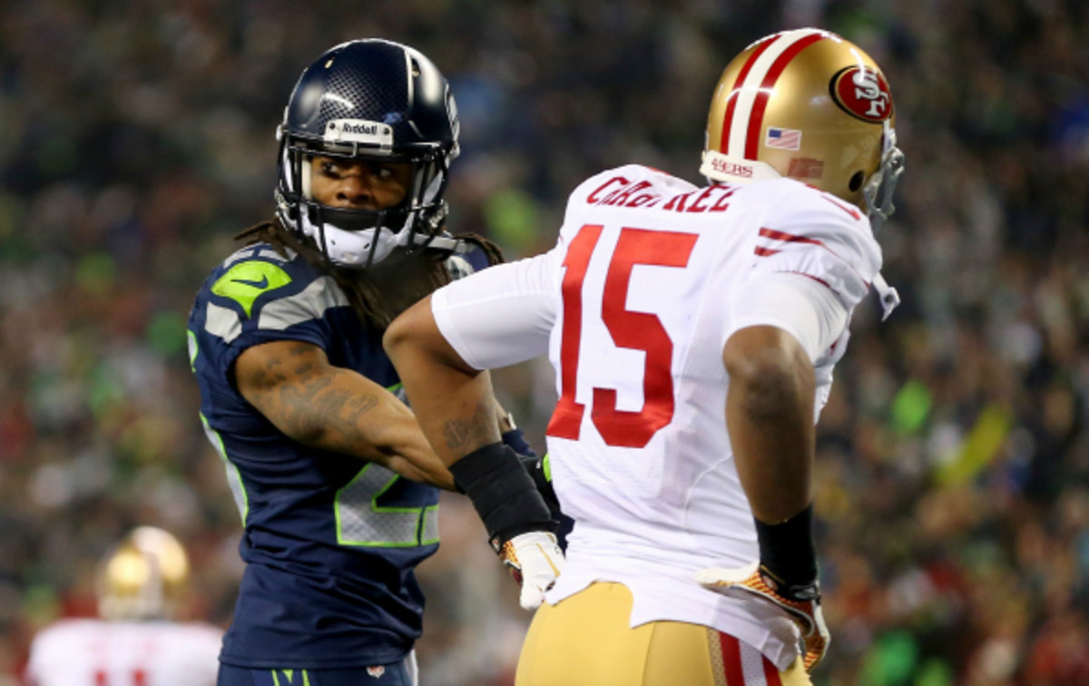 Sunday's NFC Championship game has ignited a public battle between Richard Sherman and Michael Crabtree. (Ronald Martinez/Getty Images)