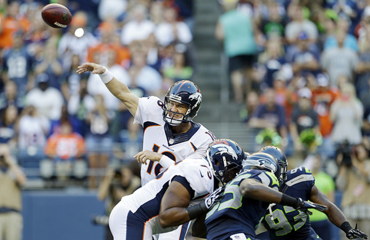 Peyton Manning (top) and his record-setting offense will face Seattle's league-best D in the Super Bowl.