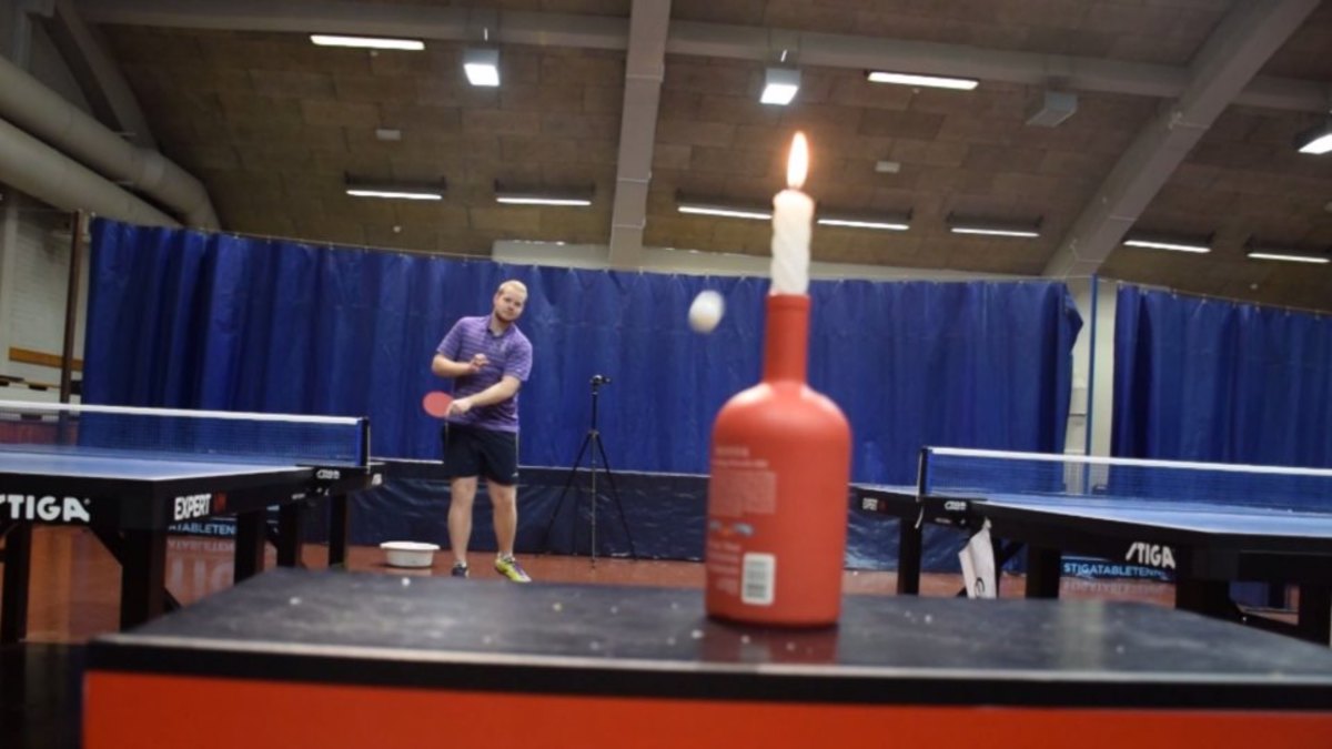 Table tennis player blows out a candle with shot