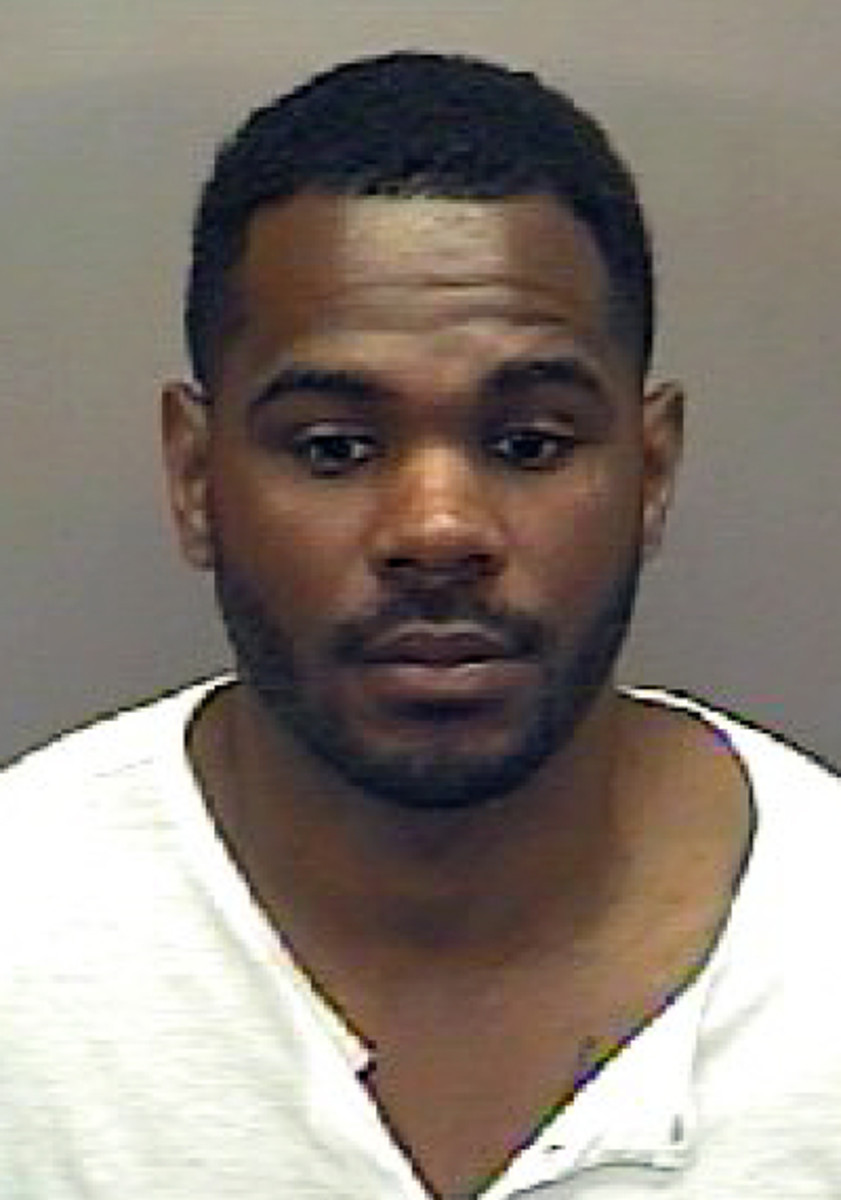 This booking photo released Tuesday, May 12, 2015, by the Orange County (N.C.) Sheriff's Office shows Christopher James Hawkins, 32, a former college football player who was arrested on Monday, May 11, and charged with acting as an agent and violating Nor