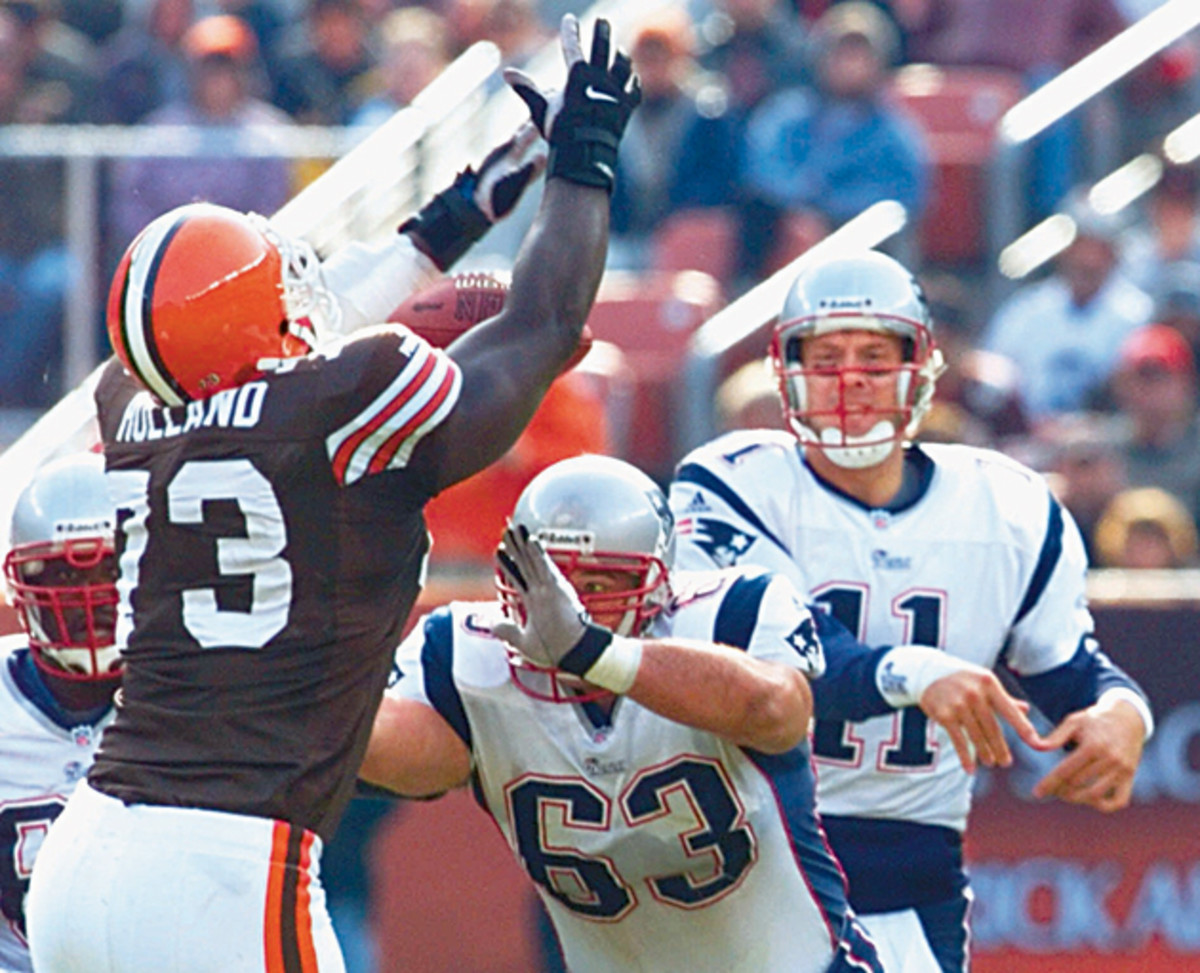New England Patriots guard Joe Andruzzi (No. 63) in action, blocking for QB Drew Bledsoe. Andruzzi feels guilty that he makes a far bigger salary than his brothers do.
