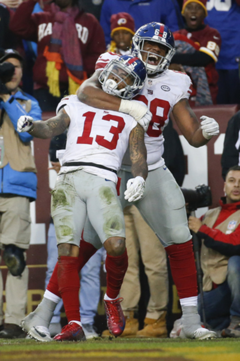 New York Giants wide receiver Odell Beckham (13) is congratulated after his touchdown catch by offensive guard Bobby Hart (68) during the second half of an NFL football game against the Washington Redskins in Landover, Md., Sunday, Nov. 29, 2015. (AP Phot