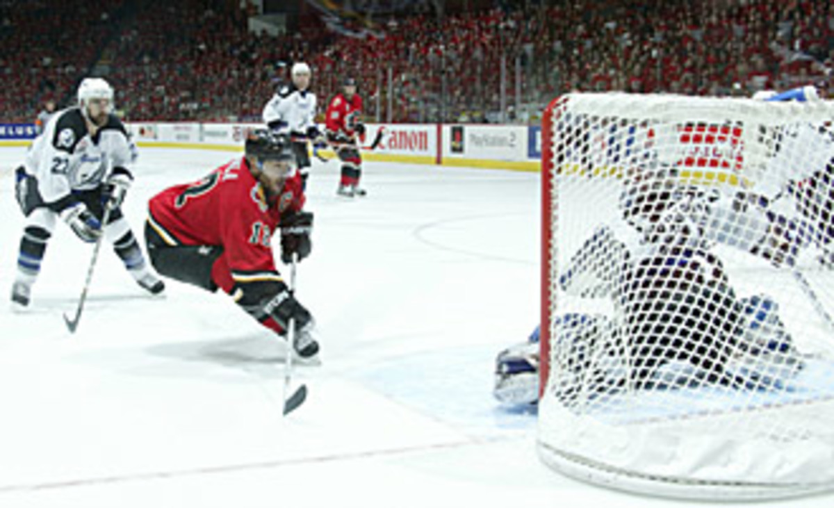 Flames captain Jarome Iginla scores on Lightning goalie Nikolai Khabibulin.