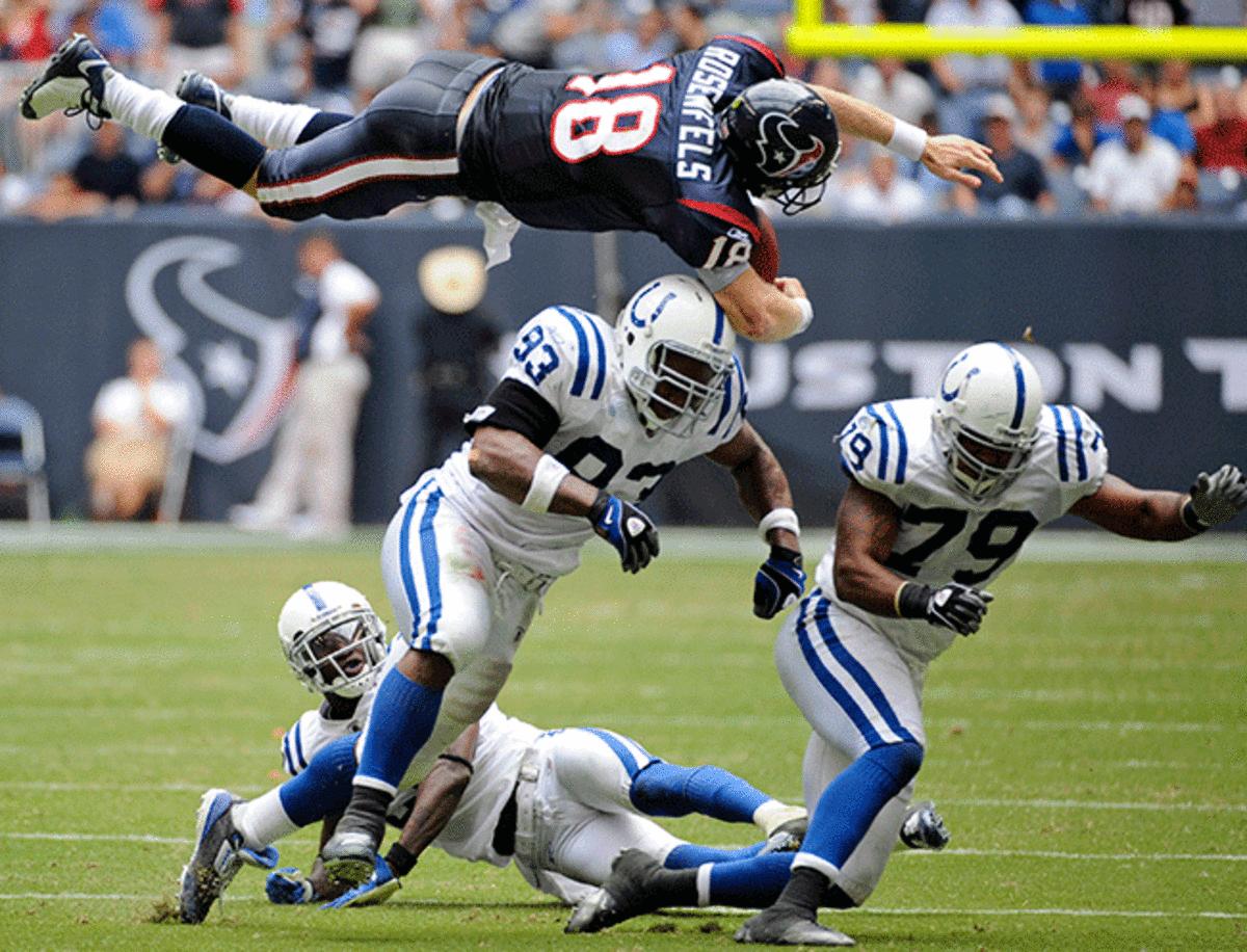 Texans quarterback Sage Rosenfels launches helicopter-style over Dwight Freeney.