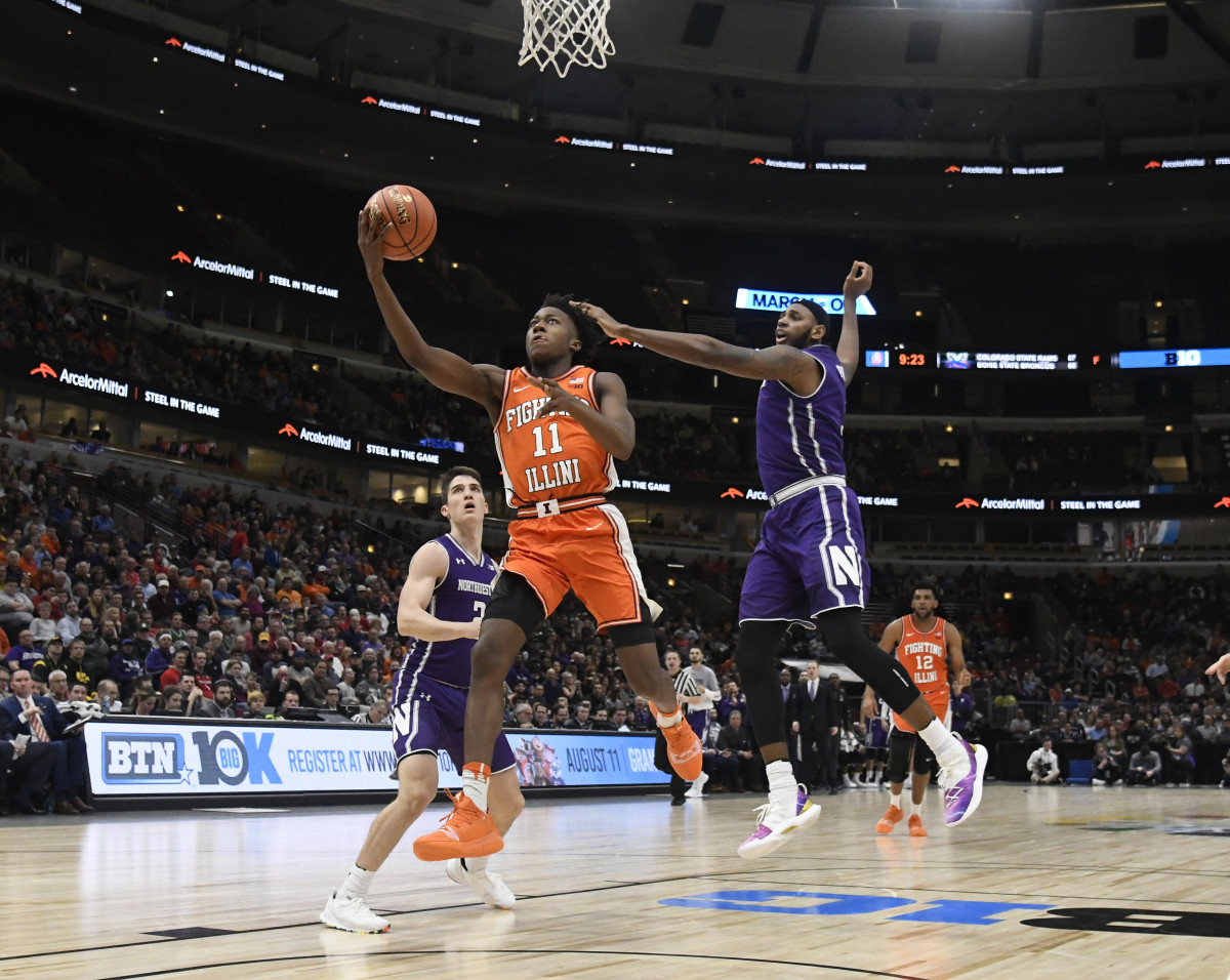 Illinois guard Ayo Dosunmu (11) goes to the basket as Northwestern center Dererk Pardon (5) defends him during the second half in the Big Ten conference tournament at United Center.