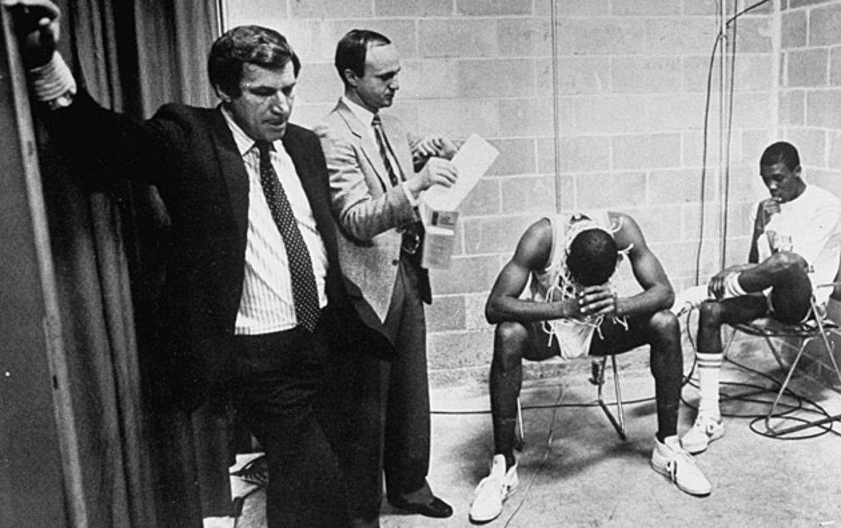 Dean Smith, SID Rick Brewer and players James Worthy (left) and Jimmy Black were the picture of tired, not triumphant, after the Tar Heels won the 1982 NCAA title.