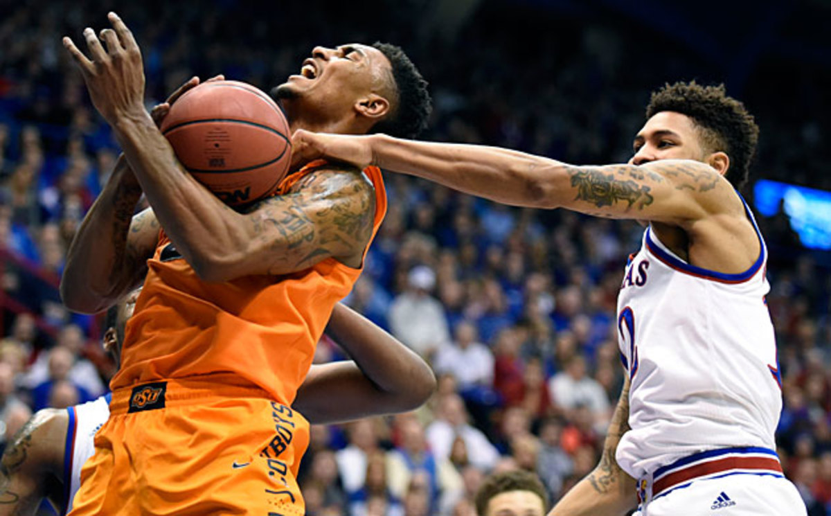 Kelly Oubre (right) helped Kansas start a four-game stretch against ranked teams by beating Le'Bryan Nash and Oklahoma State on Tuesday.