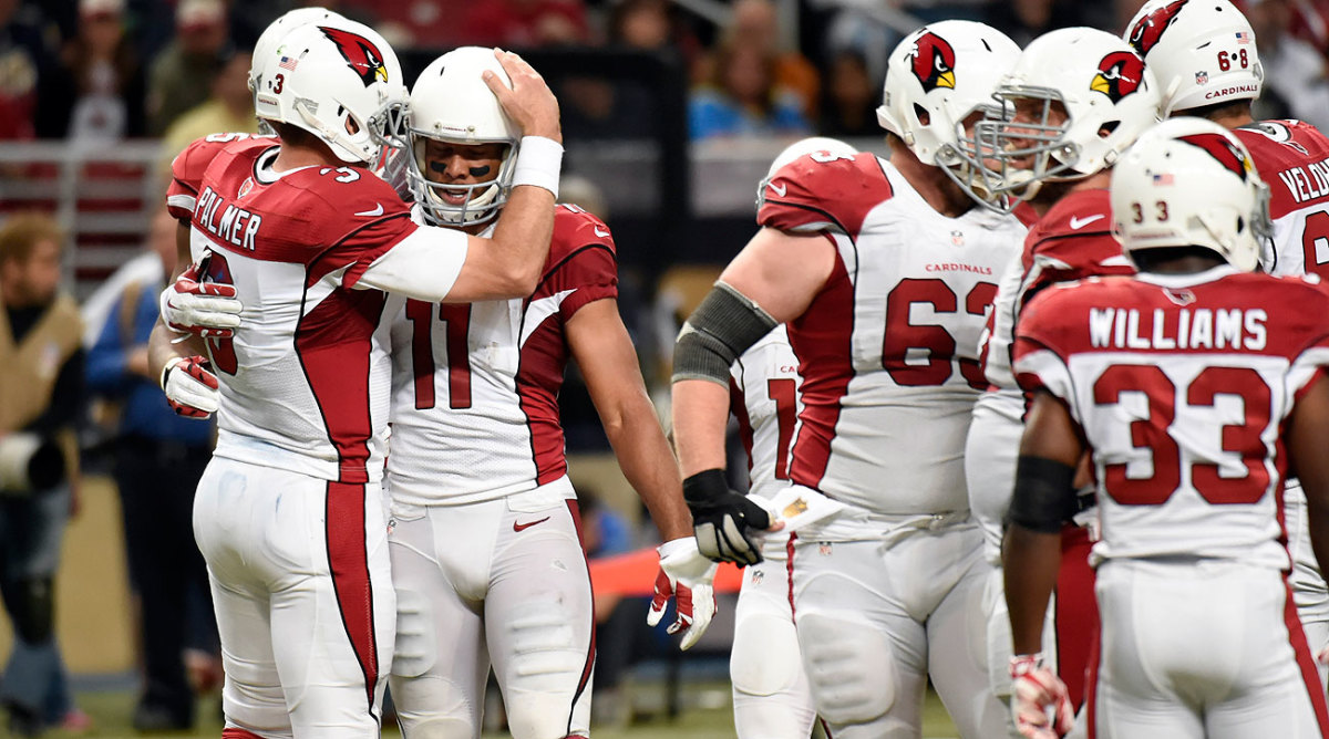 Carson Palmer congratulated Fitzgerald after his 1,000th catch. At 32, Fitzgerald is the youngest player in NFL history to reach that milestone.