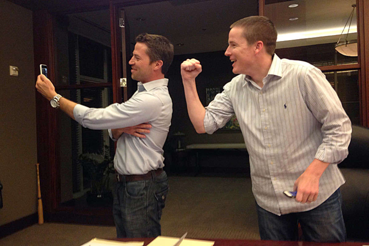 Perrett (left) and McGuire Facetime with A.J. Cann after the Jacksonville Jaguars made Cann their first client off the board. (Robert Klemko/The MMQB)