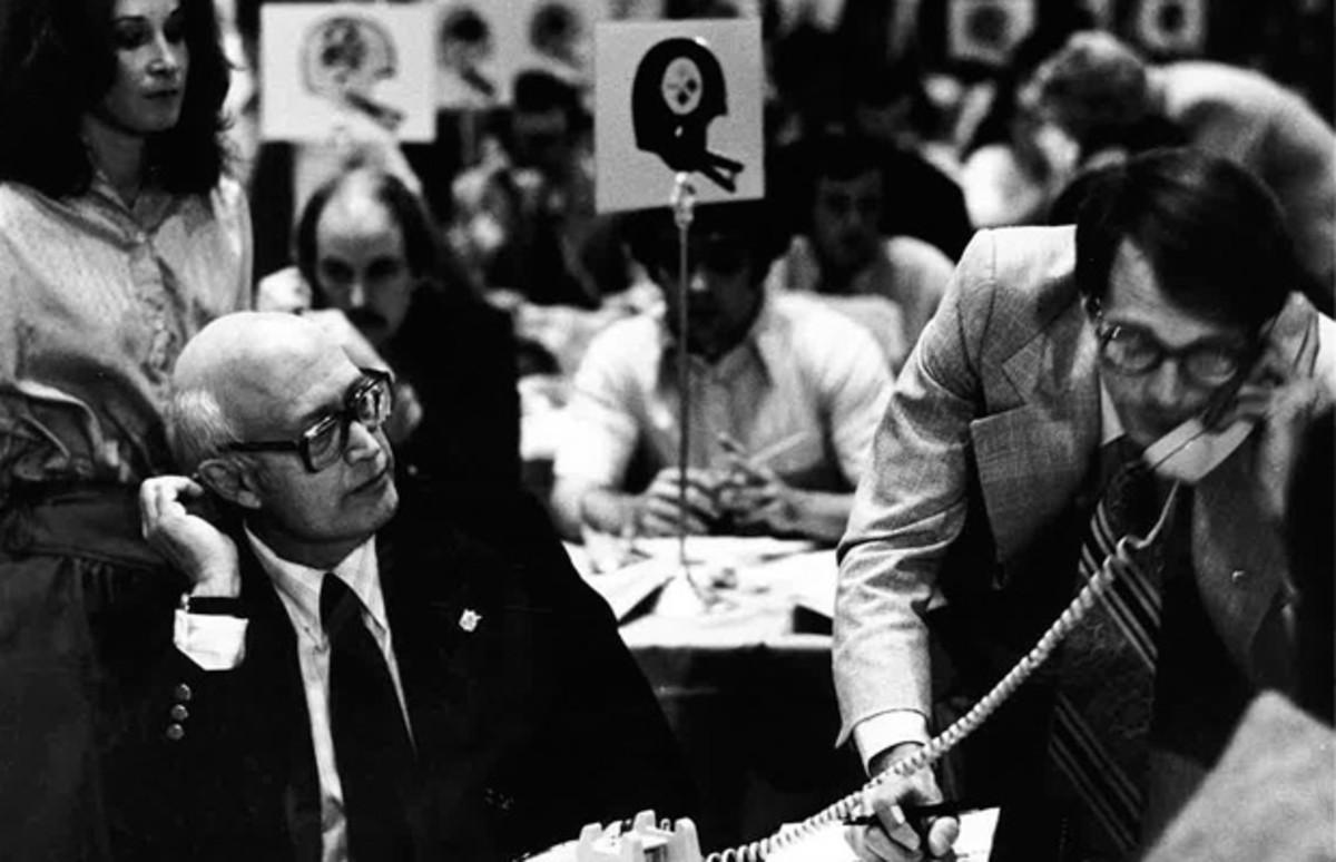 Bussert (right) works the phones at the 1979 NFL draft at the Waldorf Astoria hotel.