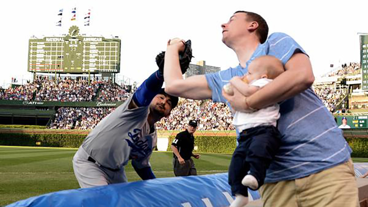 Cubs fan snags foul ball while holding baby Sports Illustrated