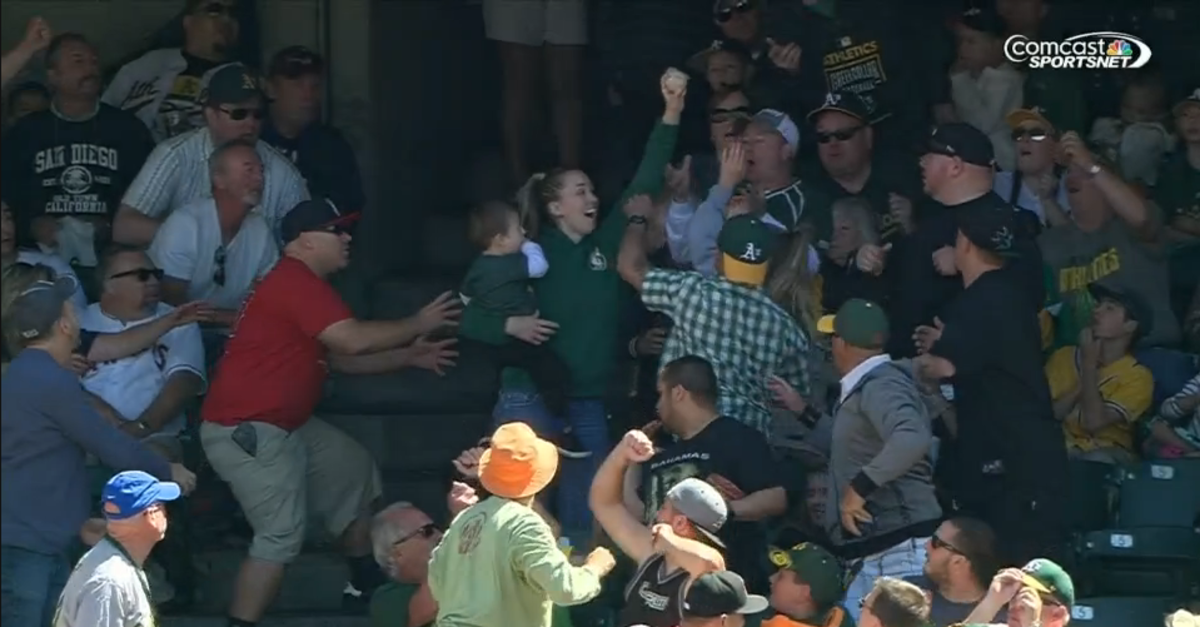 Video Oakland A's fan catches foul ball holding child Sports Illustrated
