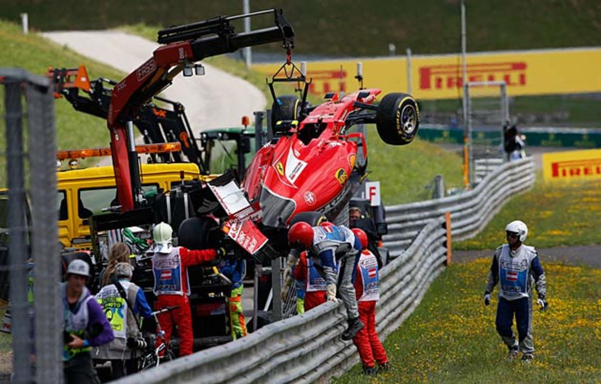 Kimi Raikkonen's car is retrieved after he crashed at the 2015 GP of Austria.