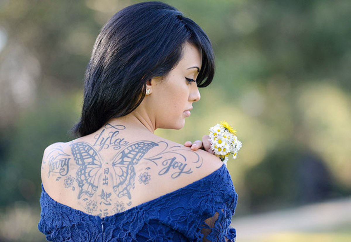 A tattoo on Bryan's back bears the names of her parents and four-year-old daughter Lyla.