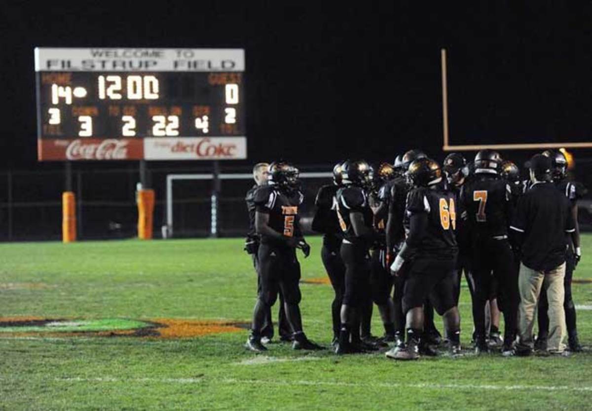 Percy Brown (No. 5) and the Tigers huddle up in the fourth quarter.