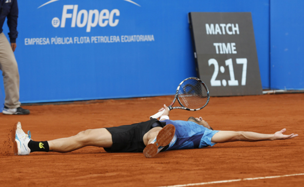 Estrella Burgos lies on the court celebrating his victory over top seed Feliciano Lopez.