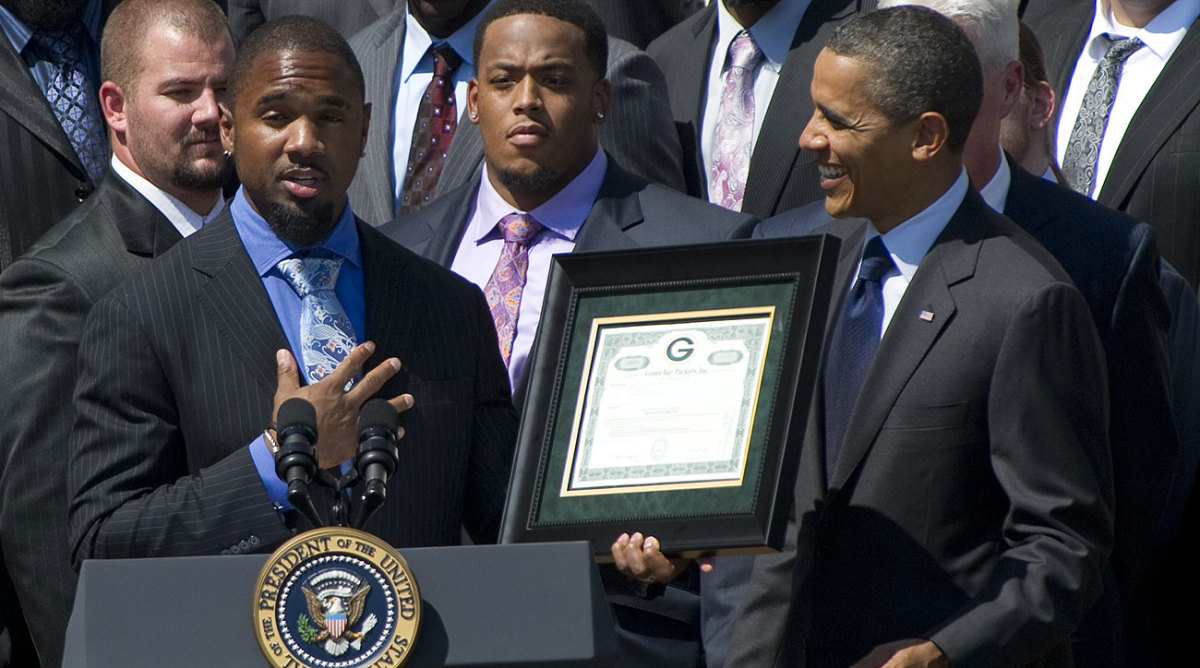 Woodson (holding frame) and the Packers visited President Obama after winning the Super Bowl following the 2010 season.