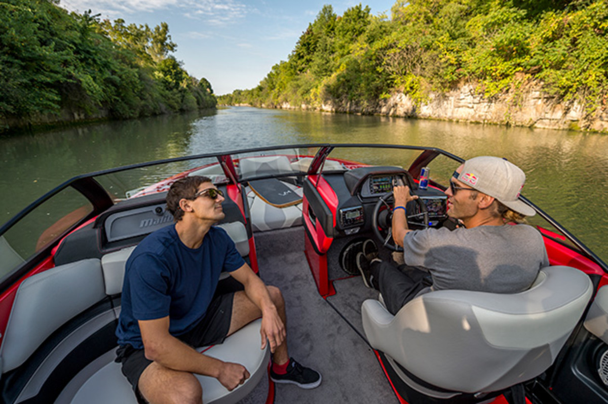 Andrew Pastura (L) and Brian Grubb (R) drive the boat down the Erie Canal in Lockport, New York.