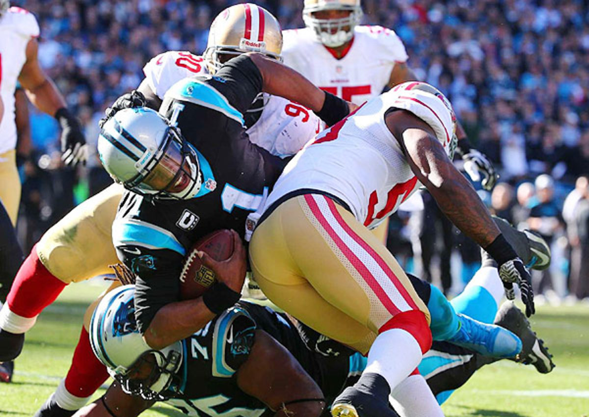 The 49ers made life miserable for Cam Newton (center), sacking him five times and twice picking him off. 